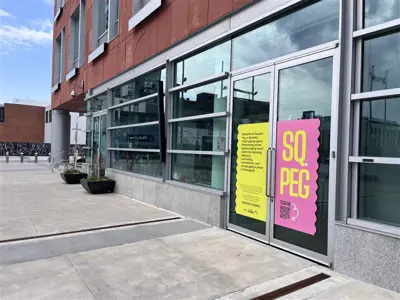 Front of building with Square Peg written on the door