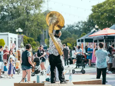 Patrons walking the block and looking at the offerings from different vendors 