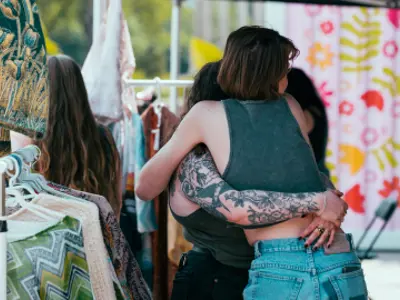 Two individuals hugging while checking out Gaukel Block